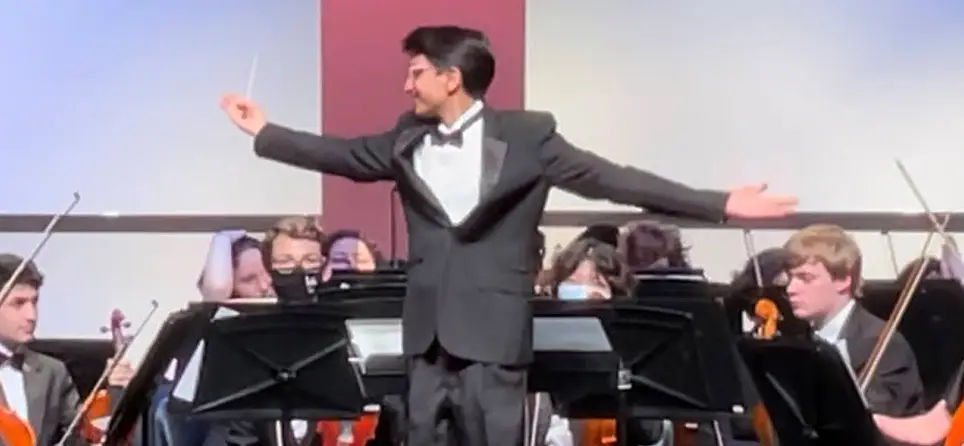 Student Kailash conducting Herndon High School orchestra